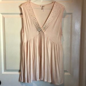 Cream color sleeveless top.